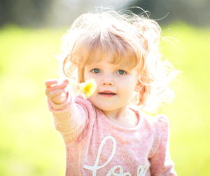 girl showing flower